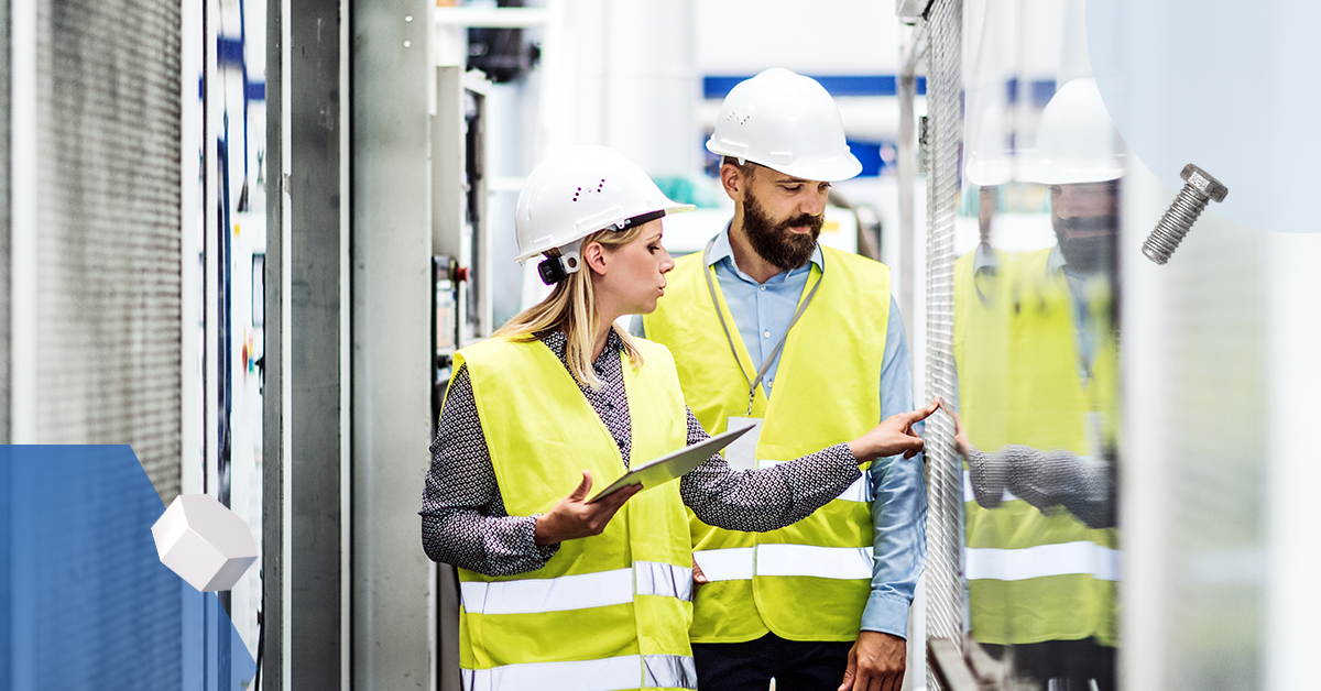 Two maintenance workers looking through glass